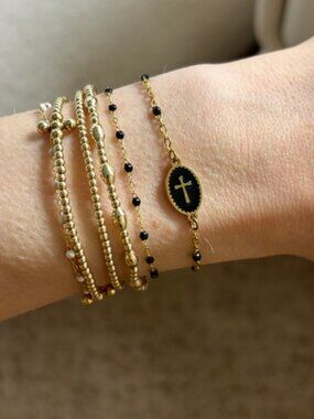 The Vega Dainty gold and black beaded look adjustable bracelet cross